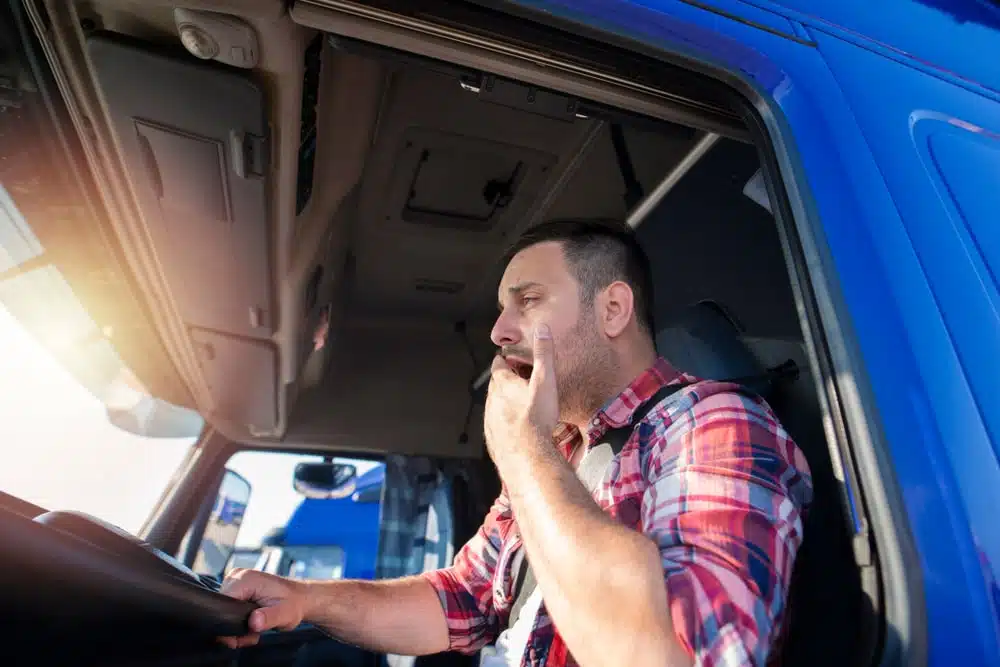 Truck Driver Yawning Sitting At The Wheel