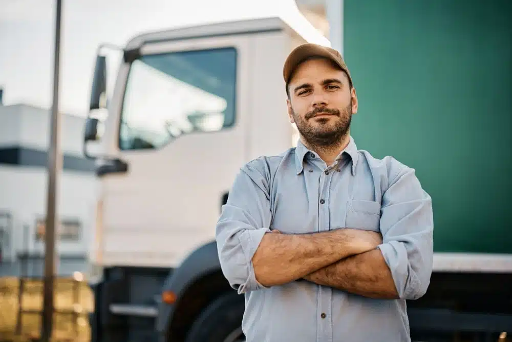 A Man Standing Next To A Truck